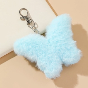 Close-up of soft light blue faux rabbit fur butterfly keychain with silver metal clip