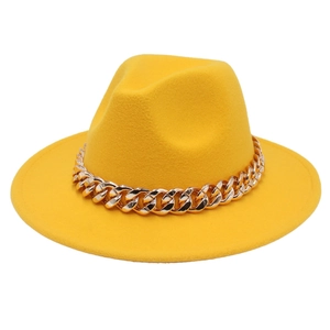 Close-up of yellow wool fedora hat featuring a chunky gold acrylic chain decoration