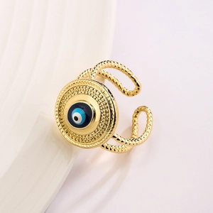 Macro shot of gold evil eye ring with blue enamel and dual-layer twisted rope band