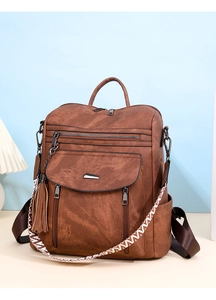 Brown faux leather multi-pocket backpack featuring stylish tassel and patterned strap