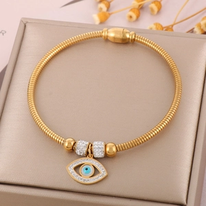 Detail of gold 18K plated evil eye bangle with paved diamonds and magnetic clasp