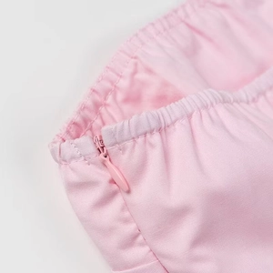 Detailed close-up of a pink strapless top showing the seamless invisible zipper