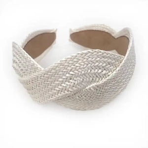 Macro shot of cream woven raffia headband showing detailed handmade braided texture