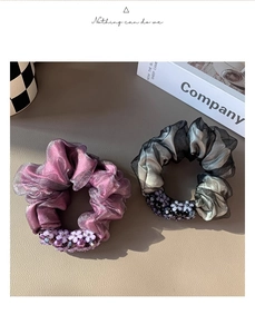 Detail of mesh scrunchies with elegant bead flower charms and metallic organza texture