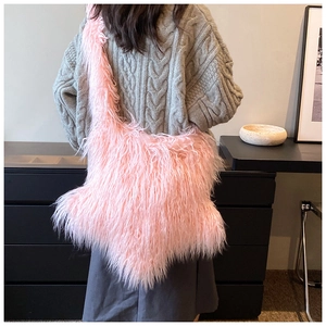 Close-up of fluffy pink plush shoulder bag worn by model showing textured faux fur style