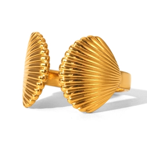 Detail view of golden scallop shell open ring showing intricate radial metal textures