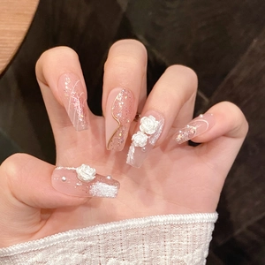 Macro shot of 3D white roses and pearls on gradient pink coffin press-on nails