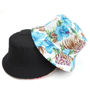 Reversible bucket hat set with solid black and tropical blue floral print patterns