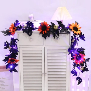 Halloween garland with orange sunflowers black maple leaves and purple LED lights