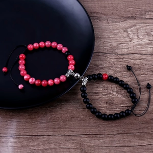 Close-up of pink marble and matte black bead bracelets with magnetic heart clasps