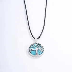 Detailed view of Tree of Life pendant with blue stones on a black wax cord necklace