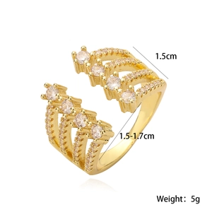 Detailed view of golden hollow-out ring with four rows of sparkling cubic zirconia