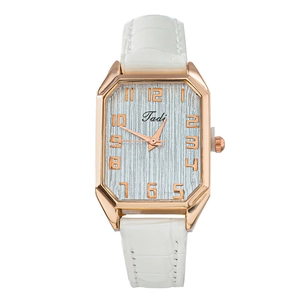 Detail of rose gold octagonal case with white crocodile pattern leather strap watch
