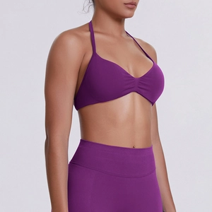 Detailed side view of purple halter neck sports bra and high-waist seamless leggings