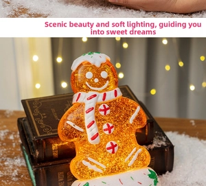 Glow gingerbread man decor with glitter on vintage books and warm festive lighting