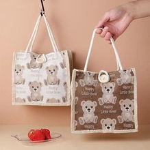 Detail of Happy Little Bear cotton linen tote bag with woven handles and button closure