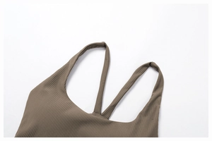 Detail of dark brown ribbed yoga tank top with fine straps and reinforced stitching
