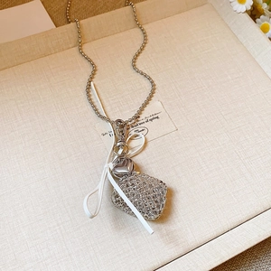 Vintage starfish heart pendant necklace with mesh pouch on a soft beige linen tray