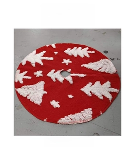 Flat lay of a red plush Christmas tree skirt featuring white flocked tree and snowflake patterns