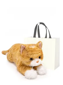Realistic orange tabby cat plush toy with white gift bag and black handles detail