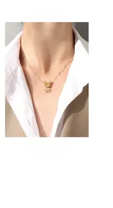 Detail of a minimalist 18K gold-plated rabbit pendant necklace worn by a female model