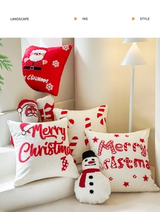 Detailed view of tufted Christmas pillows with festive embroidery on white steps