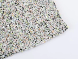 Vue macro de la texture du tissu tweed à paillettes colorées et fibres tissées
