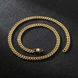 Detailed view of a gold Cuban link chain with a secure lobster clasp on dark background