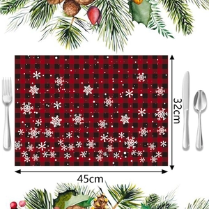 Detail view of red and black buffalo plaid Christmas placemat with snowflake patterns