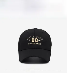 Close-up of black baseball cap with detailed white embroidery on cotton fabric