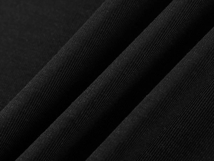 Close-up of black ribbed Tencel fabric showing vertical texture and soft drape
