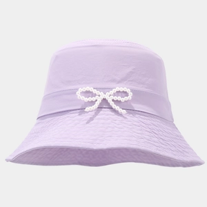 Detailed view of lavender bucket hat featuring a delicate white pearl bow embellishment
