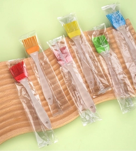 Set of six colorful food-grade silicone oil brushes for BBQ and pastry on a wood tray
