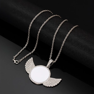 Silver hip hop wing locket necklace with rhinestones on a black textured background
