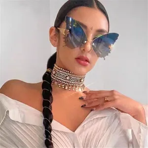 Frameless butterfly sunglasses with blue gradient lenses and bohemian rhinestone jewelry
