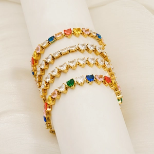 Macro detail of gold-plated heart-shaped zircon tennis bracelets in rainbow colors