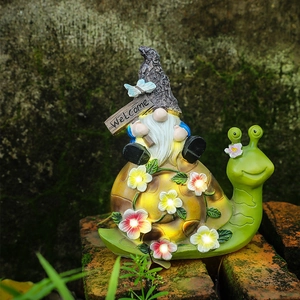 Solar powered garden gnome riding a snail with LED flowers and Welcome sign