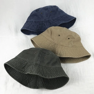 Short brim washed cotton bucket hats in navy, khaki, and grey with metal eyelets