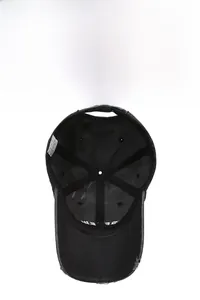 Detail view of cotton baseball cap interior showing black stitching and care label
