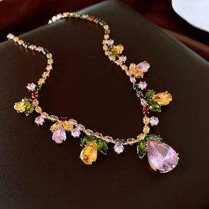 Macro shot of luxury colorful pear-cut zircon leaf necklace on premium leather background