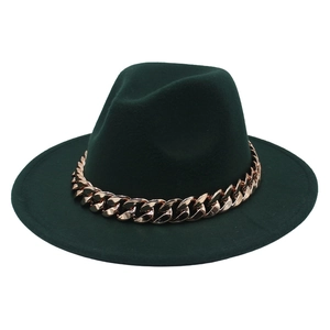 Detail of dark green felt fedora hat featuring a chunky rose gold acrylic chain decoration