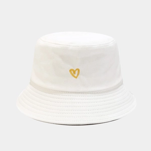 Close-up of yellow heart embroidery and reinforced stitching on white cotton bucket hat