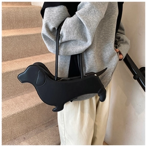 Close-up of black dachshund-shaped shoulder bag made of high-quality faux leather material