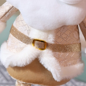 Close-up of champagne Christmas doll showing intricate jacquard fabric and plush details