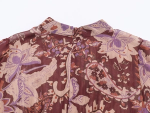 Detail of red paisley chiffon dress featuring a stand collar and invisible back zipper