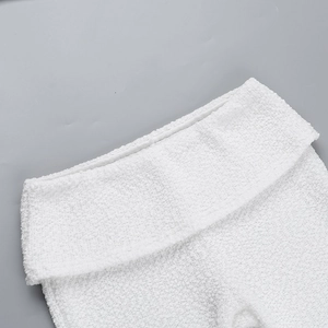 Close-up of white plush texture and wide folded waistband detail on lounge set