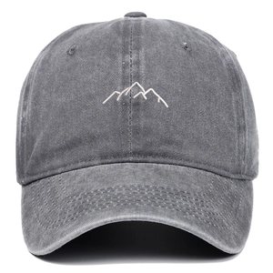 Detail of grey washed baseball cap showing white mountain embroidery and cotton texture