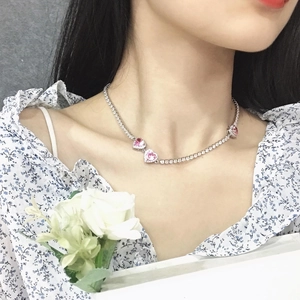Detail of pink heart-shaped gems on a sparkling zircon choker necklace worn by a model