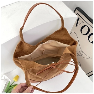 Top view of large brown suede tote bag showing beige lining and interior pockets