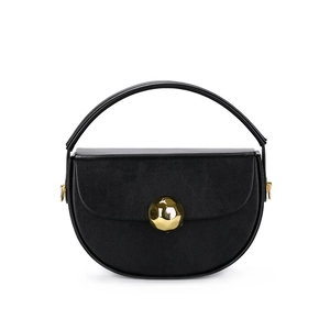 Fashionable black semi-circular hard shell handbag with a gold spherical metal clasp